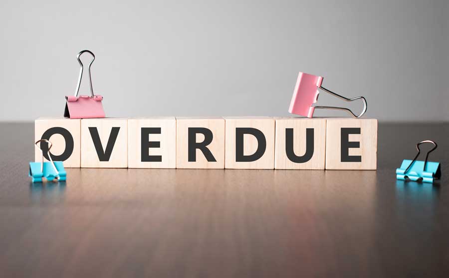 wooden blocks spelling out the word "overdue" 